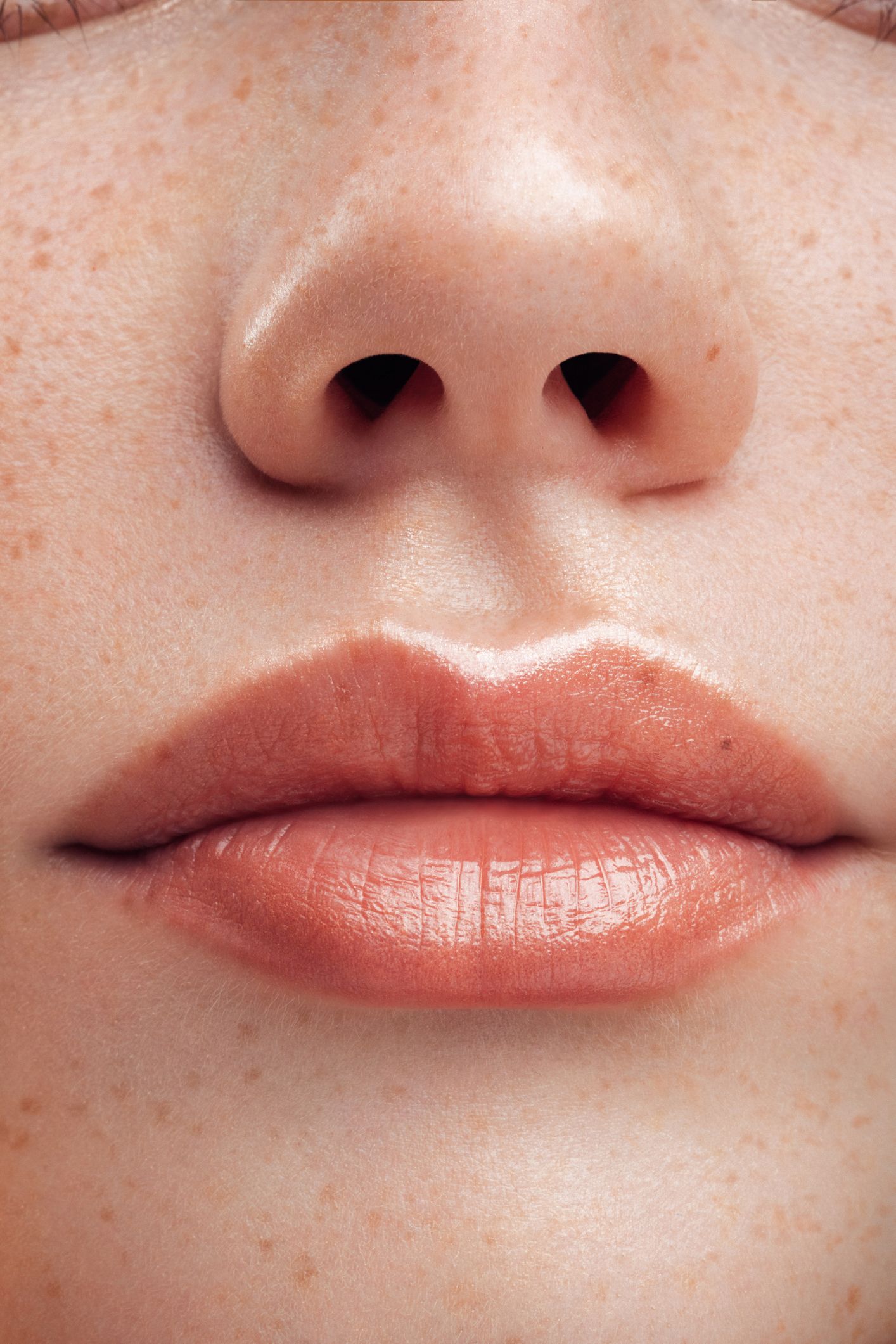 Part of woman's face. Woman's lips and nose. Soft skin.