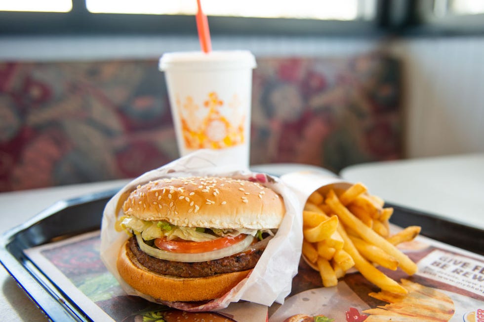 an impossible whopper sits on a table at a burger king restaurant