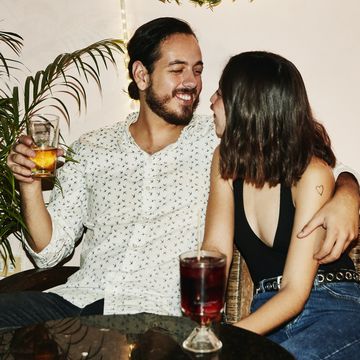 smiling couple embracing during date at night club