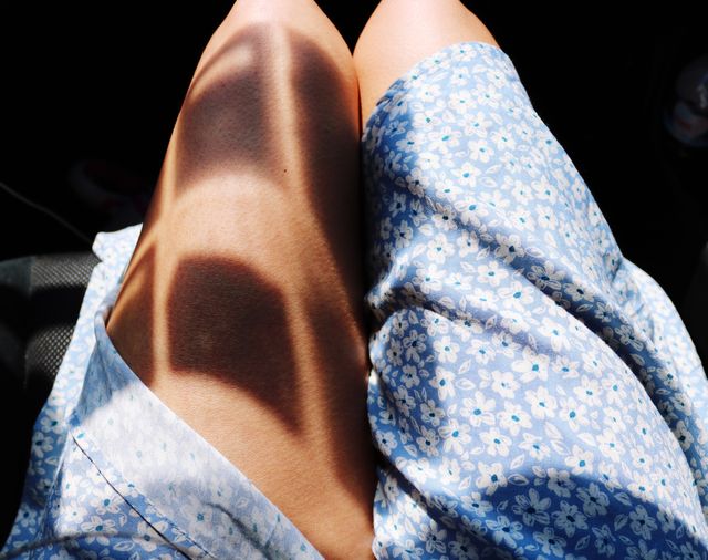 Sunlight Falling On Legs Of Woman