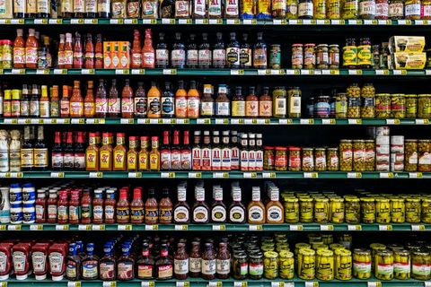 Condiment brands displayed on the shelves of a grocery store
