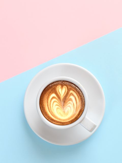 A cup of coffee with heart pattern