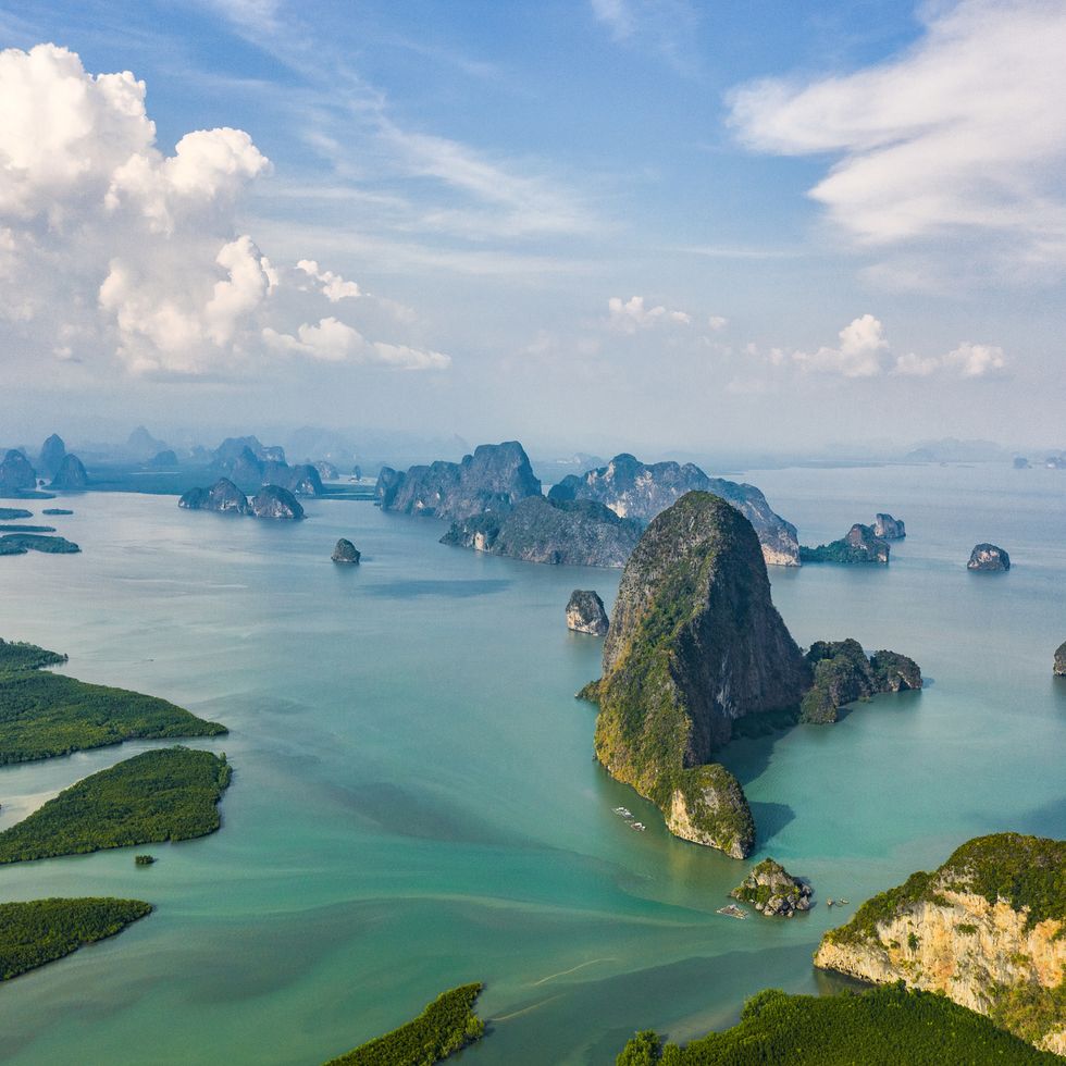 view from above, aerial view of the beautiful phang nga bay ao phang nga national park with the sheer limestone karsts that jut vertically out of the emerald green water, thailand