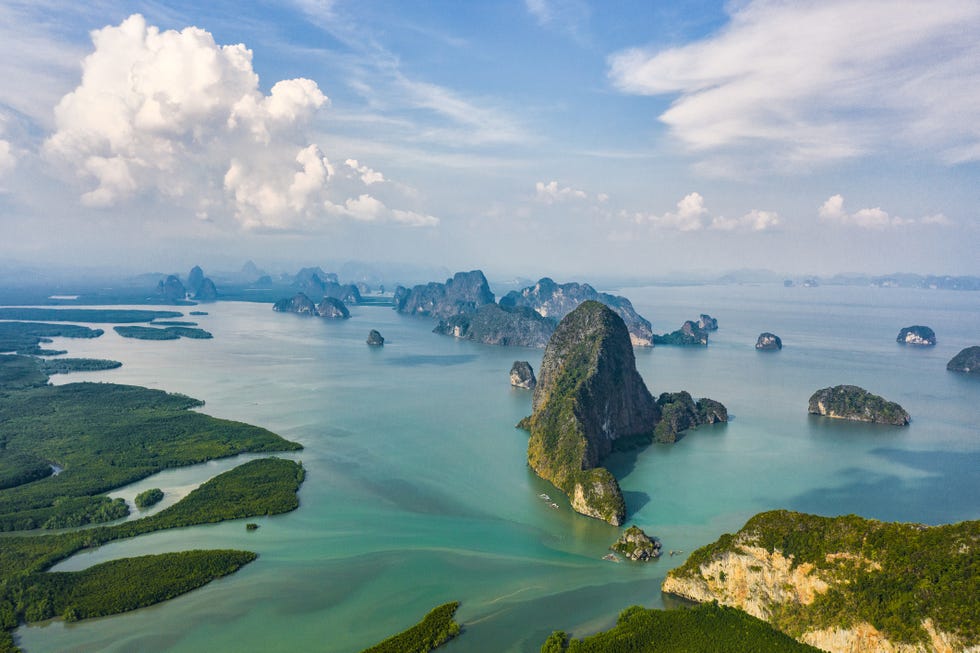 view from above, aerial view of the beautiful phang nga bay ao phang nga national park with the sheer limestone karsts that jut vertically out of the emerald green water, thailand