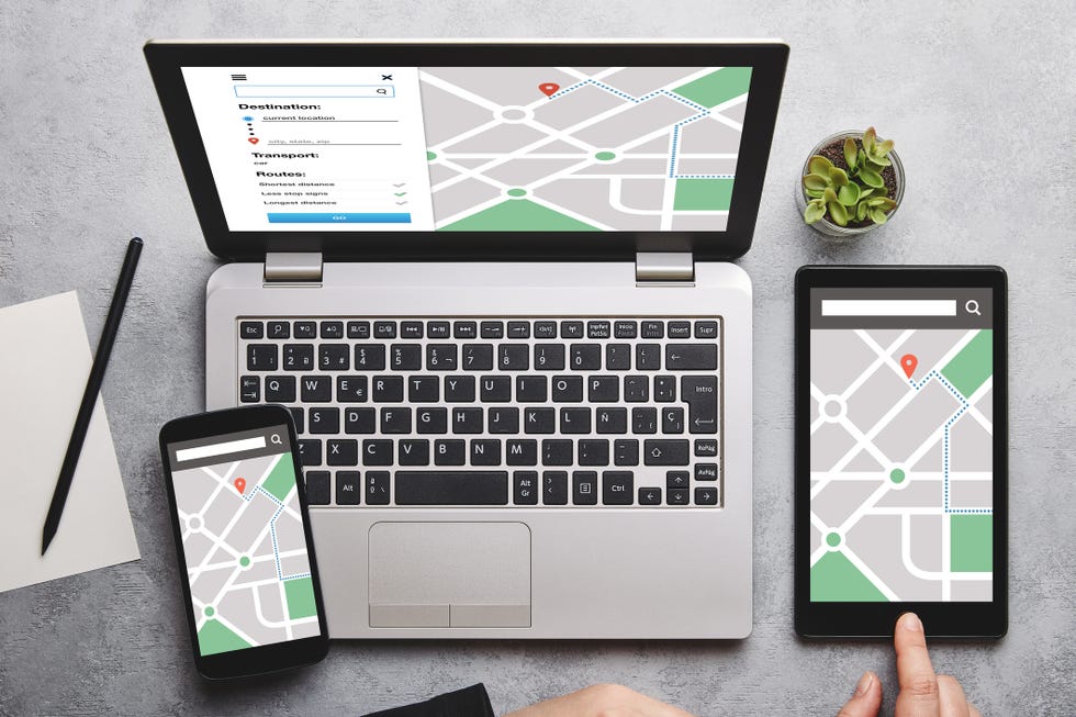 Location tracker concept on laptop, tablet and smartphone screen location tracker concept on laptop, tablet and smartphone screen over gray table all screen content is designed by me flat lay