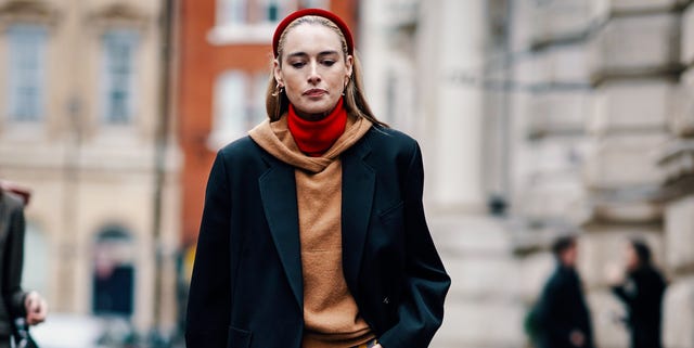 london, england   february 16 a guest wears a red headband, earrings, a red turtleneck, a camel hoodie, a black oversize jacket, wide leg blue and yellow check pants, during london fashion week february 2019 on february 16, 2019 in london, england photo by edward berthelotgetty images
