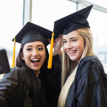 high school grads take selfie after their graduation ceremony