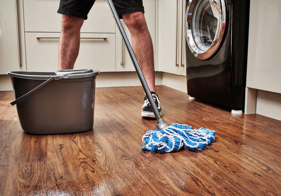 detail of a man cleaning a wooden kitchen floor with a mop and bucket, taken on march 3, 2018 photo by olly curtist3 magazinefuture via getty images