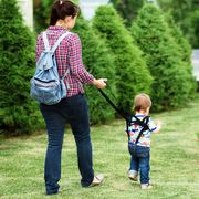Mom insures her child during a walk
