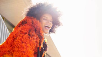 woman leaning towards camera laughing