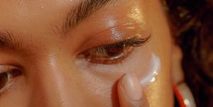 Closeup of a Young Confident Woman Applying Eye Cream