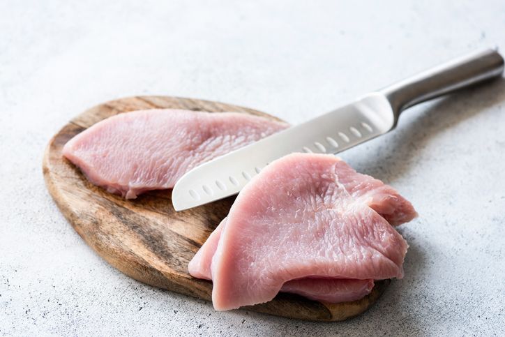 raw turkey meat steaks on a wooden cutting board meat ready for cooking