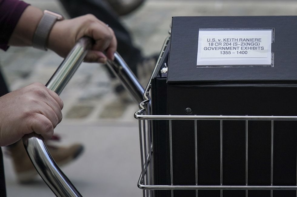 new york, ny   may 7 staff and members of the prosecution team push carts full of court documents related to the us v keith raniere case as they arrive at the us district court for the eastern district of new york a, may 7, 2019 in the brooklyn borough of new york city opening arguments begin on tuesday morning for the trial of keith raniere, the leader of the alleged sex cult nxivm raniere, who could potentially face life in prison, has pleaded not guilty to sex trafficking, racketeering and other charges photo by drew angerergetty images