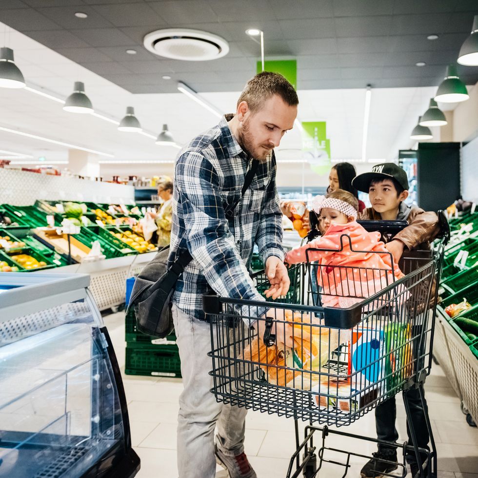 a family buying groceries together at their local supermarket
