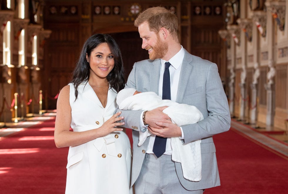 britains prince harry, duke of sussex (r), and his wife meghan, duchess of sussex, pose for a photo with their newborn baby son, archie harrison mountbatten windsor, in st georges hall at windsor castle in windsor, west of london on may 8, 2019. (photo by dominic lipinski / pool / afp) (photo credit should read dominic lipinski/afp via getty images)