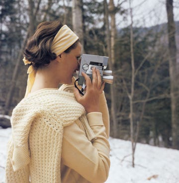 a young woman filming with a wollensak eyematic 8mm movie camera on the slopes of the sugarbush mountain ski resort in warren, vermont, usa, circa 1960 the sugarbush resort is one of the largest ski resorts in new england photo by slim aaronsgetty images