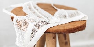 white delicate lace bra on a wood  stool