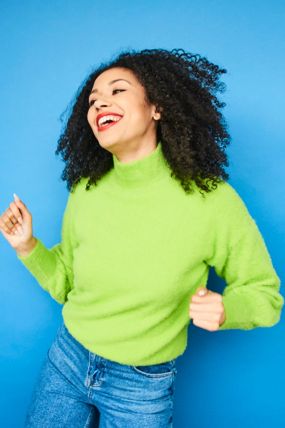 colourful studio portrait of a young woman dancing