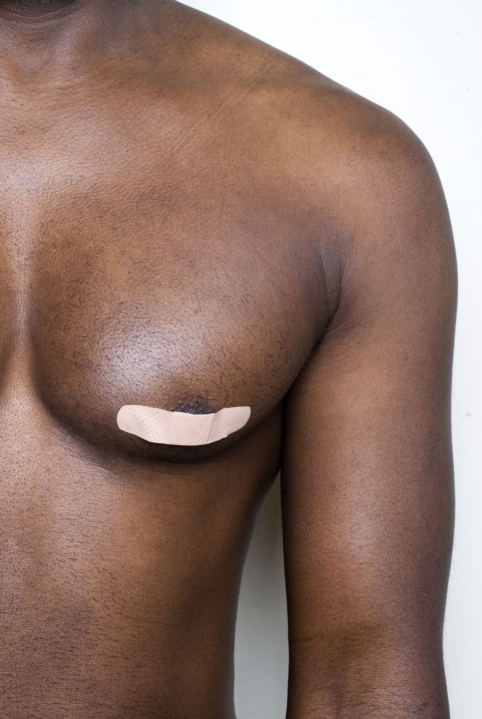 man with bandages on nipples for protection while marathon running