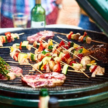 fresh healthy food grilling on bbq, meat cooking with cubed mediterranean vegetables, sizzling, temptation, party