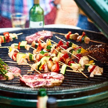 fresh healthy food grilling on bbq, meat cooking with cubed mediterranean vegetables, sizzling, temptation, party