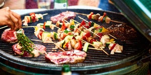 fresh healthy food grilling on bbq, meat cooking with cubed mediterranean vegetables, sizzling, temptation, party