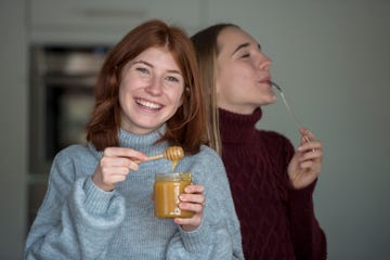 a couple of women drinking from a glass