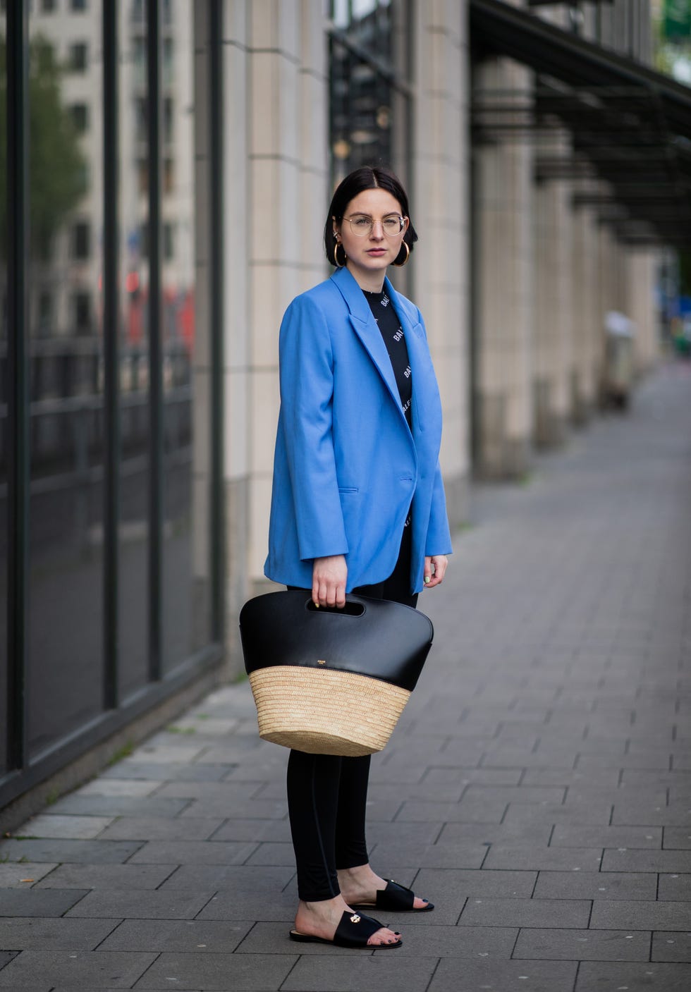 duesseldorf, germany may 05 maria barteczko is seen wearing blue oversized blazer zara, black long longsleeve balenciaga, black leggings nike, black slipper march muse, raffia basket bag celine, hoops galleria armadoro, diamond ear cuff fendi, ray ban glasses on may 05, 2019 in duesseldorf, germany photo by christian vieriggetty images