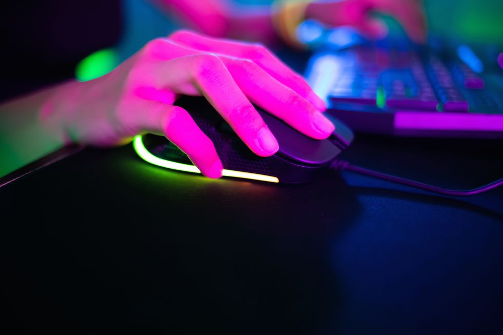 close up of cyber sport gamer play game and click the mouse