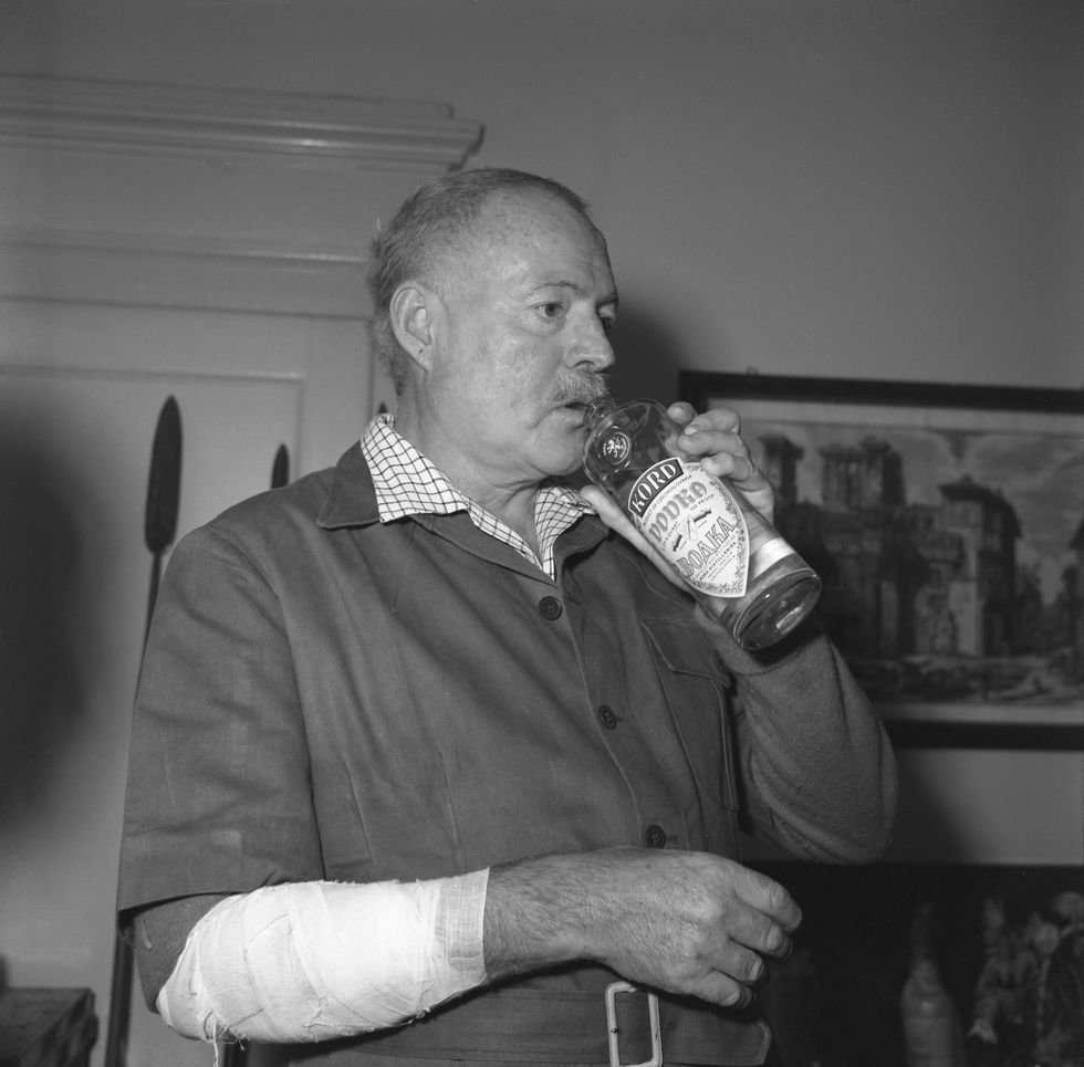 Ernest Hemingway, wearing drinking vodka from the bottle, Venice 1954