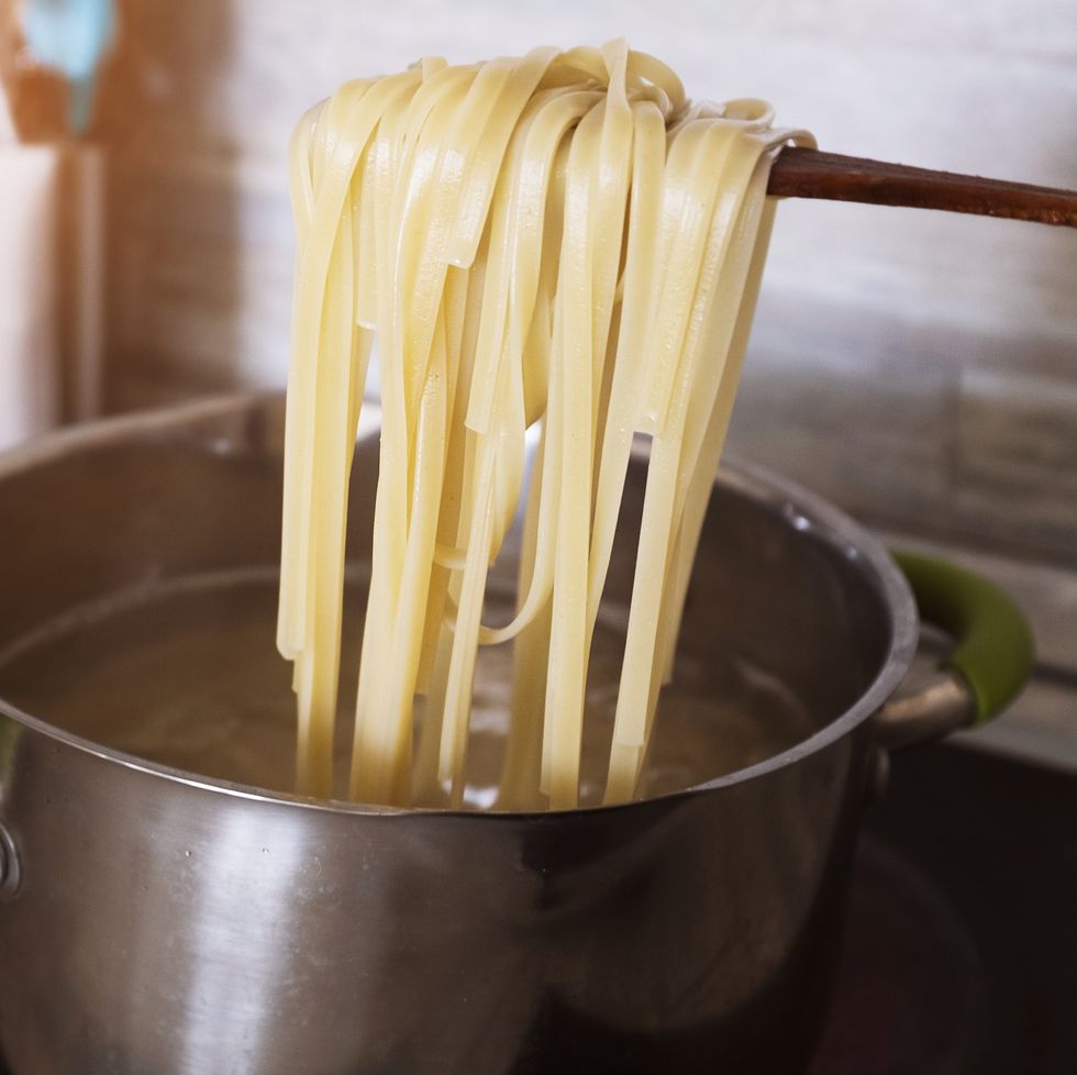Cooking pasta at home in a pan. Spaghetti