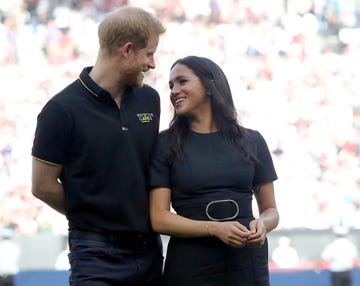 london, england   june 29 prince harry, duke of sussex and meghan, duchess of sussex accompany invictus games competitors on the field for the ceremonial first pitch before game one of the london series between the new york yankees and the boston red sox at london stadium on saturday, june 29, 2019 in london, england photo by alex trautwigmlb via getty images