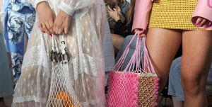 vrouwen dragen plastic nettassen tijdens fashion show