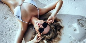 attractive young caucasian woman in maldives enjoying vacation, lifestyle, beautiful young adult woman, tropical island, resort, turquoise water, swimwear, luxury vacation