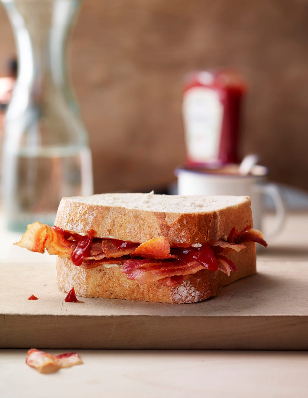 a rustic bacon and tomato sauce sandwich in table setting