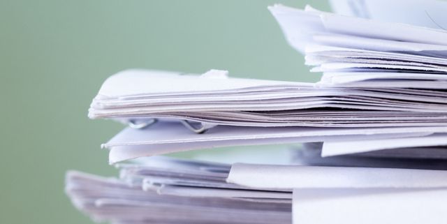 Pile of papers on a work table.