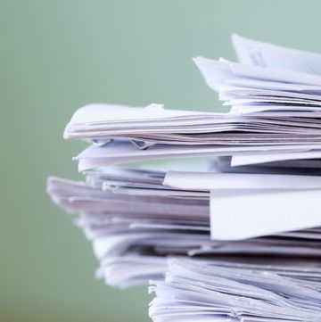 Pile of papers on a work table.