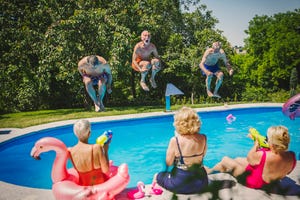 active seniors having fun at swimming pool