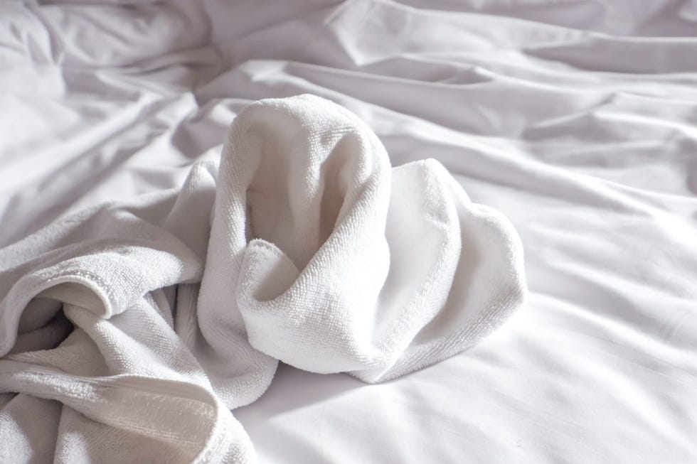 white towels used on the bed in the hotel room.