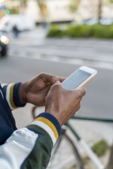 Close-up of man using cell phone in the city