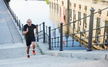 portrait of an active senior man doing exercise in the city