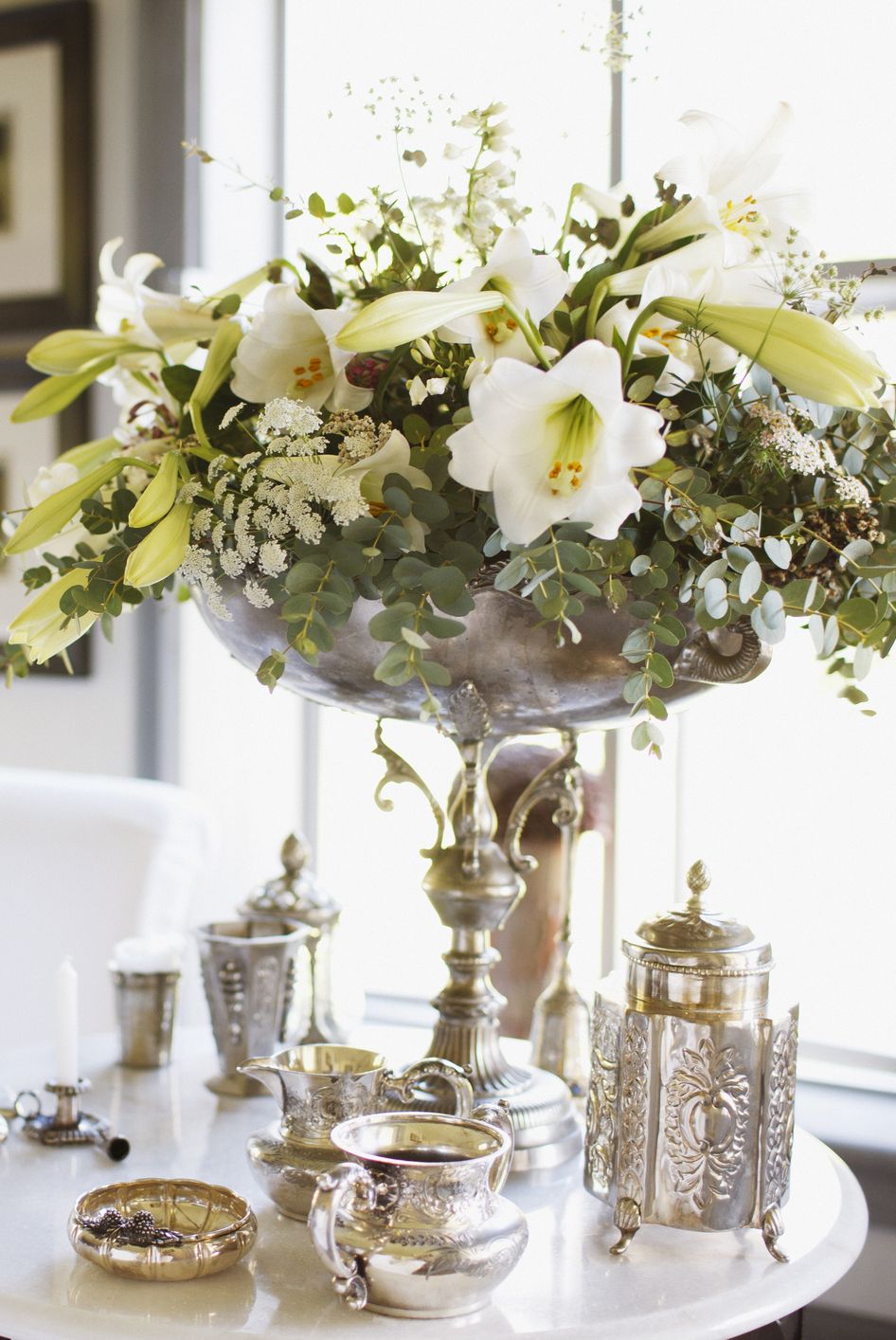 a vase with white flowers on a table