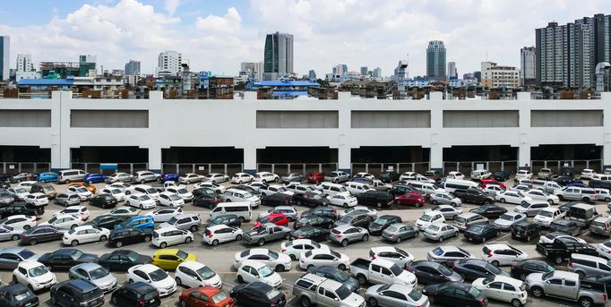 High Angle View Of Cars Parked In Street Against Cloudy Sky
