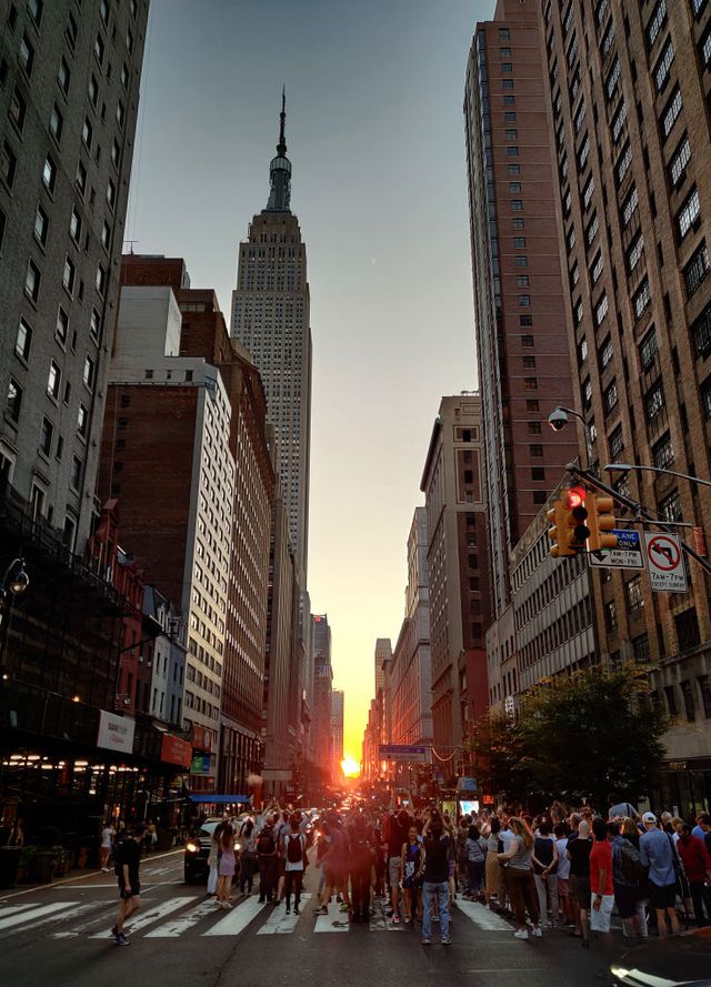 new york, ny   july 13 the sun sets along 34th street behind the empire state building during a manhattanhenge sunset on july 13, 2019 in new york city photo by gary hershorngetty images