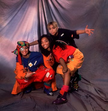 the members of american hip hop and rb group tlc pose backstage during an appearance on an episode of the oprah winfrey show, chicago, illinois, november 17, 1992. pictured are, lisa 'left eye' lopes (1971 2002) (in blue and orange), tionne 't boz' williams (blond hair), and rozanda 'chilli' thomas. (photo by paul natkin/getty images)