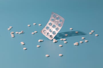 an empty blister pack surrounded by pills