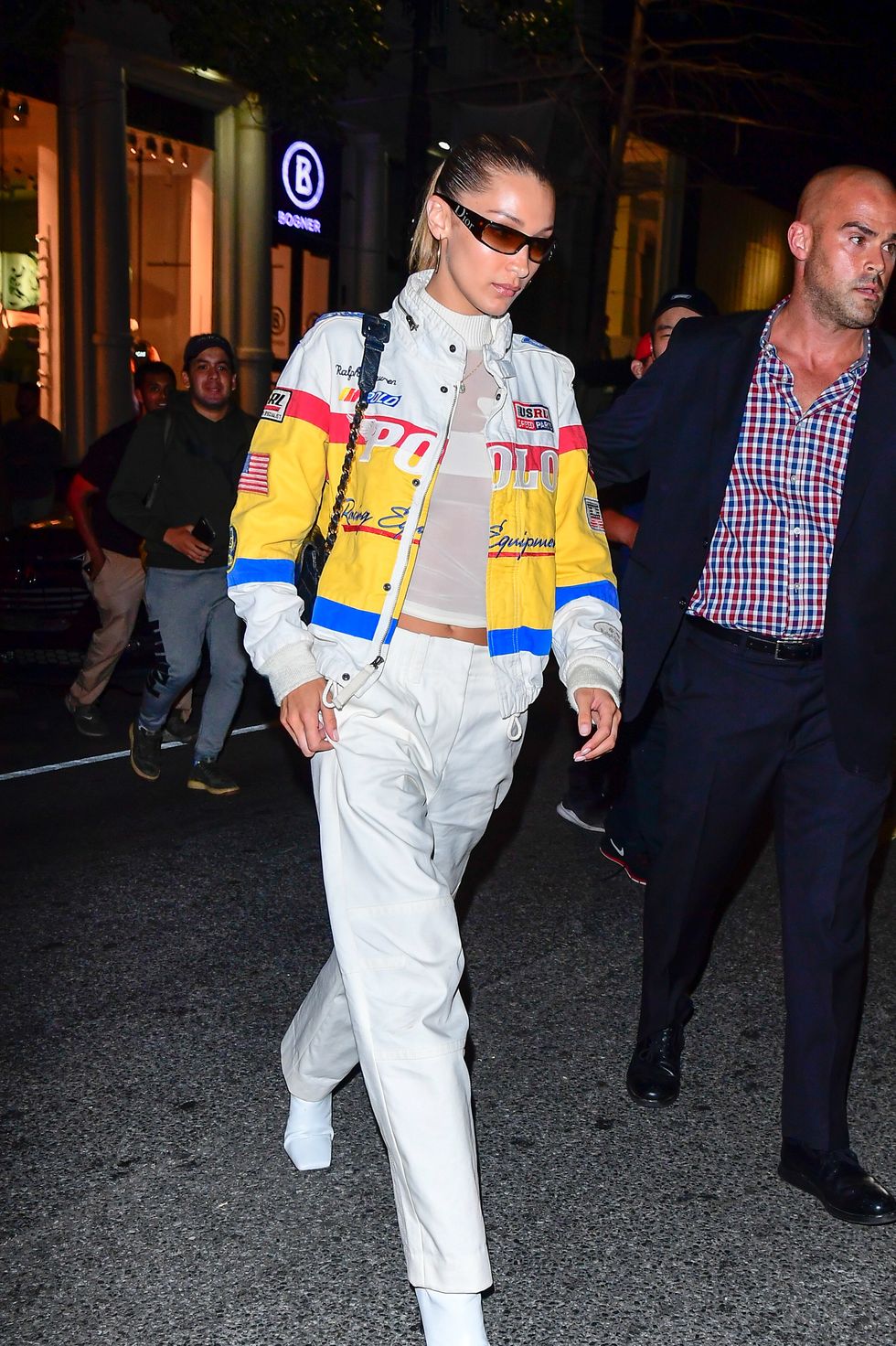 Bella Hadid in neon yellow vest and white sneakers in New York on