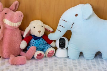 nanny cam monitoring in a baby crib with children toys