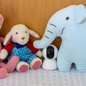 nanny cam monitoring in a baby crib with children toys nanny cam monitoring in a baby crib with children toys