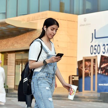 saudi manahel al otaibi, a 25 year old activist, checks her mobile as she walks in western clothes in the saudi capital riyadhs al tahliya street on september 2, 2019 with her high heels clacking on marble tiles, a defiant saudi woman turned heads and drew gasps as she strutted down a riyadh mall without a body shrouding abaya the billowy robe, commonly all black, is an over garment that is customary in public for women in the ultra conservative islamic kingdom, where it is widely seen as a symbol of piety last year, de facto ruler crown prince mohammed bin salman hinted the dress code may be relaxed amid his sweeping liberalisation drive, saying the robe was not mandatory in islam photo by fayez nureldine  afp photo credit should read fayez nureldineafp via getty images